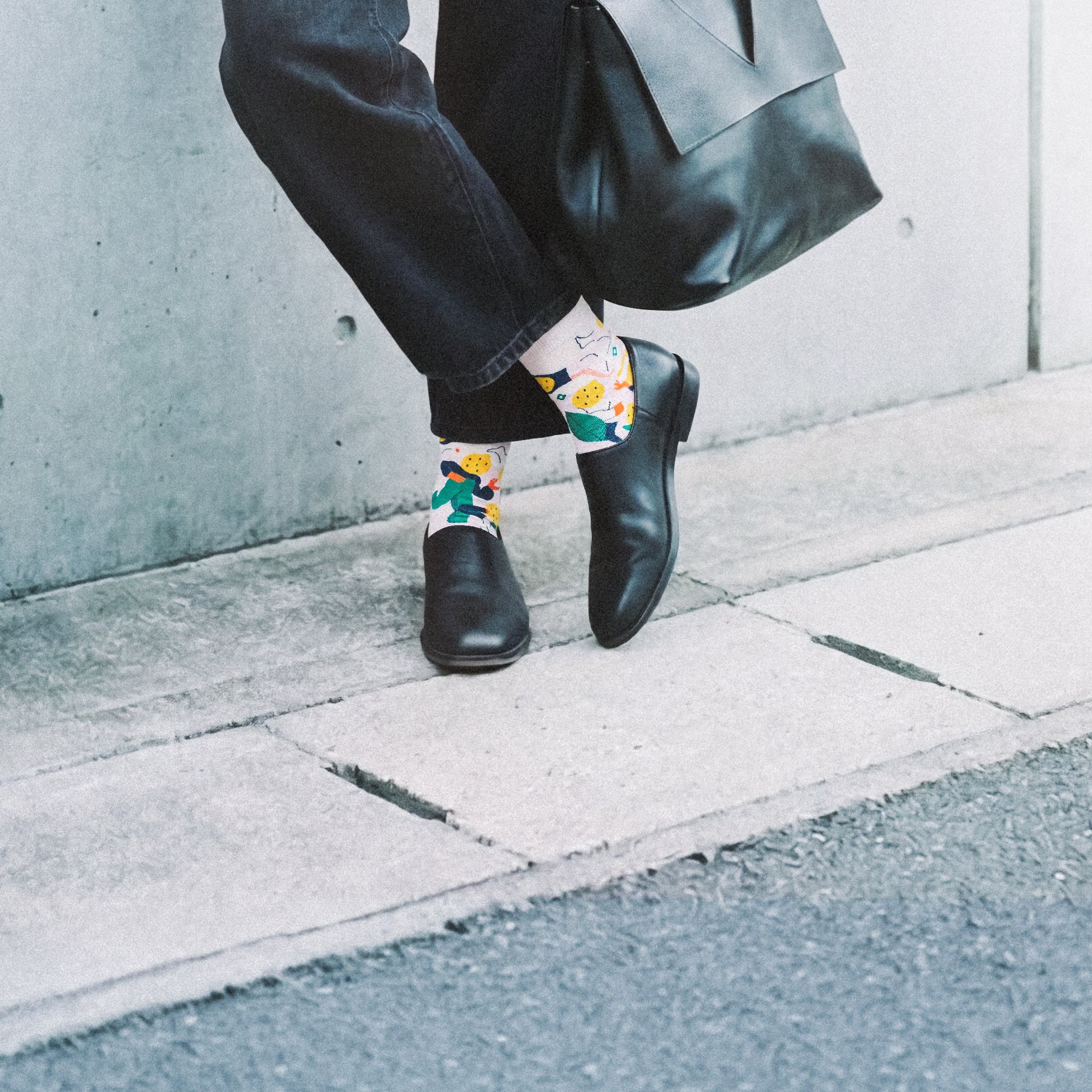 Woman cropped legs with leather tote on sidewalk wearing Limono Lemonheads Rose socks
