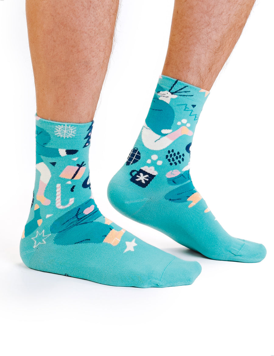Limono Christmas Turquoise socks with dancing Santa, deer and gift motifs worn on legs