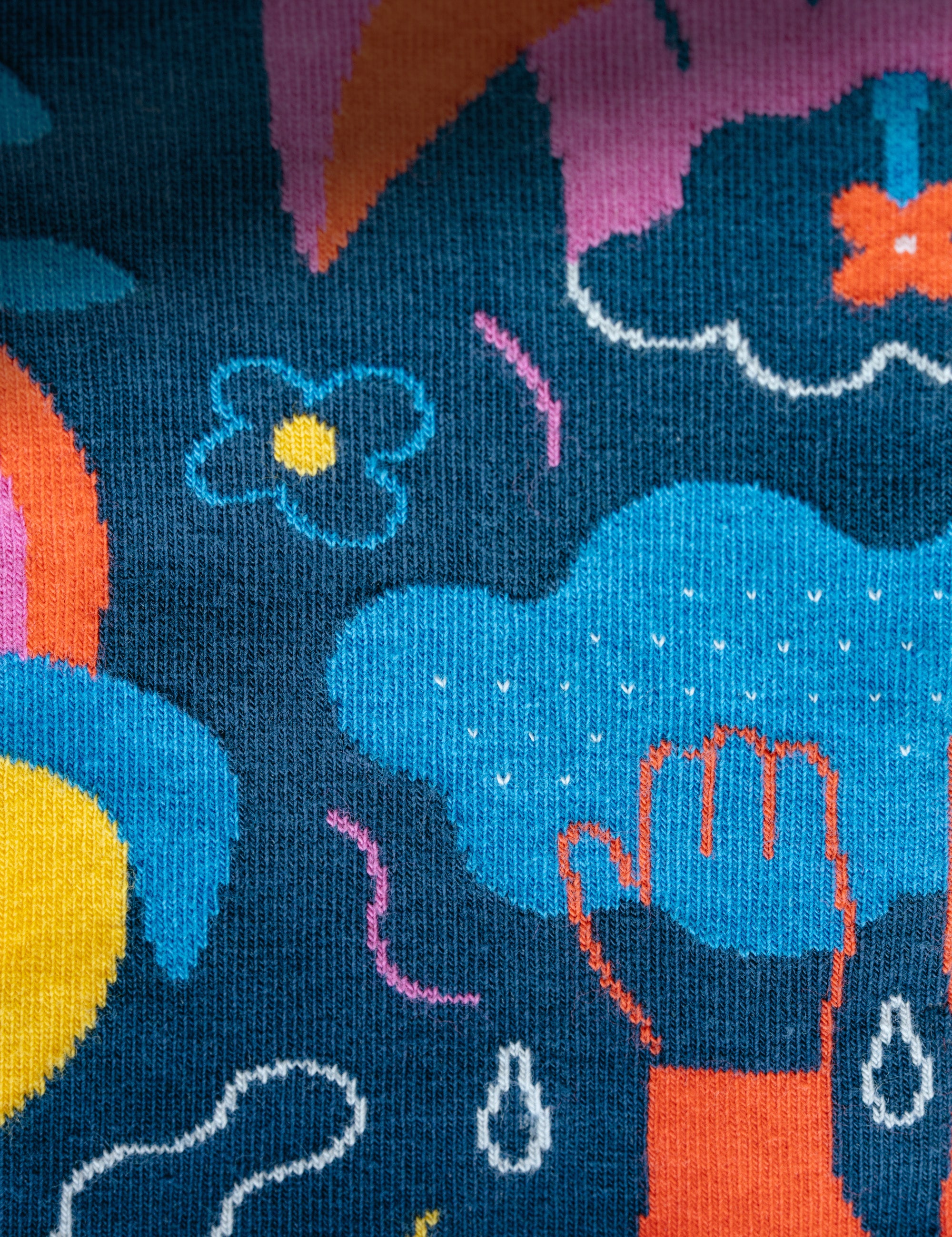 Limono Rain Clouds Black socks jacquard knit macro showing cloud-head character and raindrops