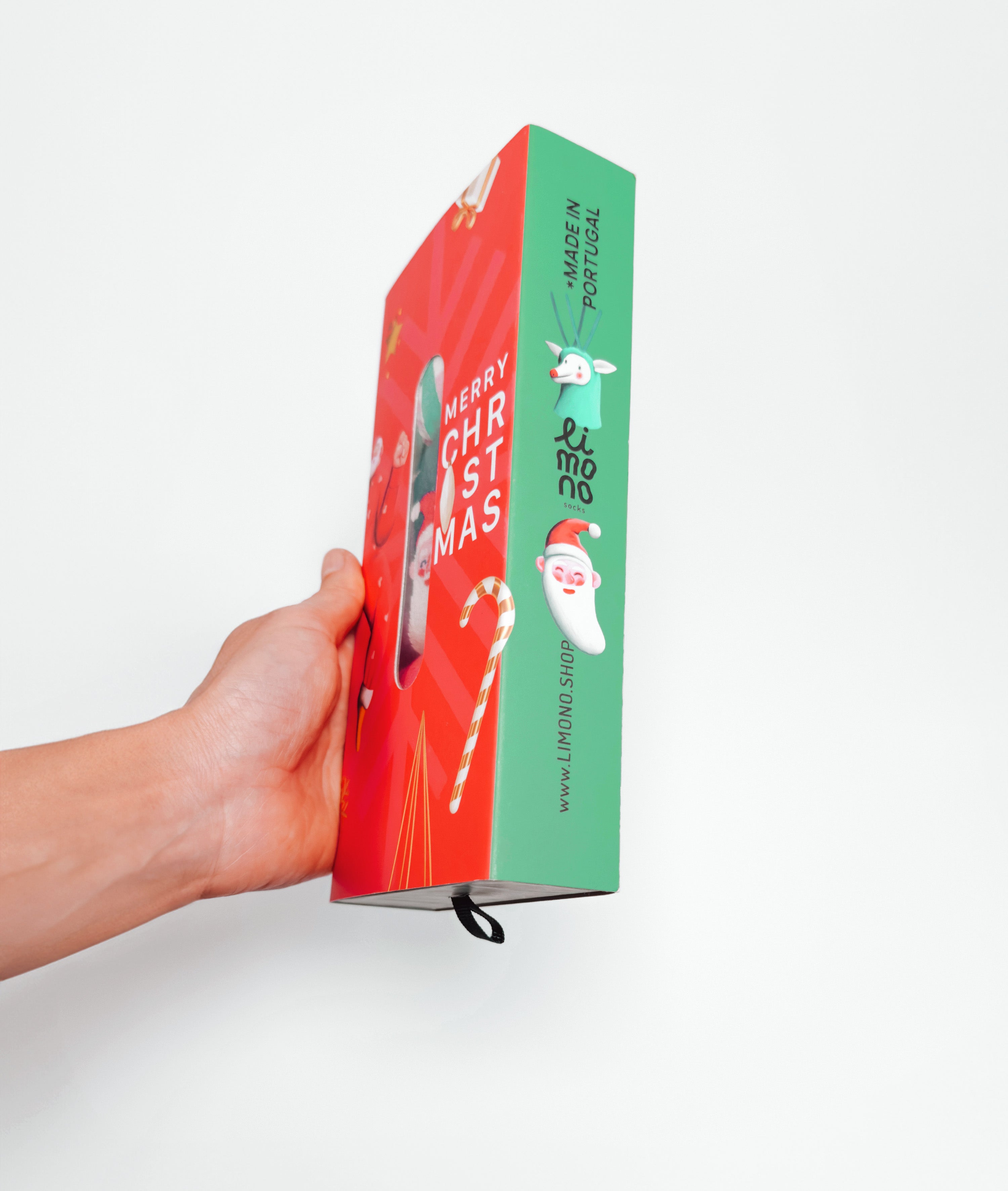 Limono Christmas gift box held in hand side view with Santa and reindeer characters