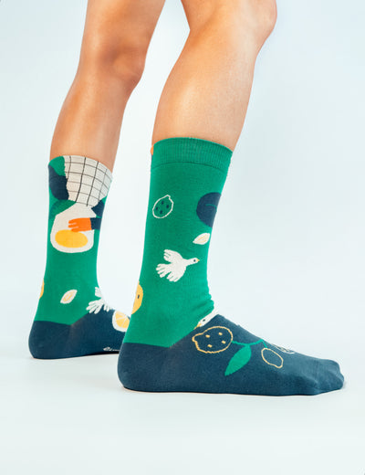 Cropped legs back view on white wearing Limono Lemonheads Green socks