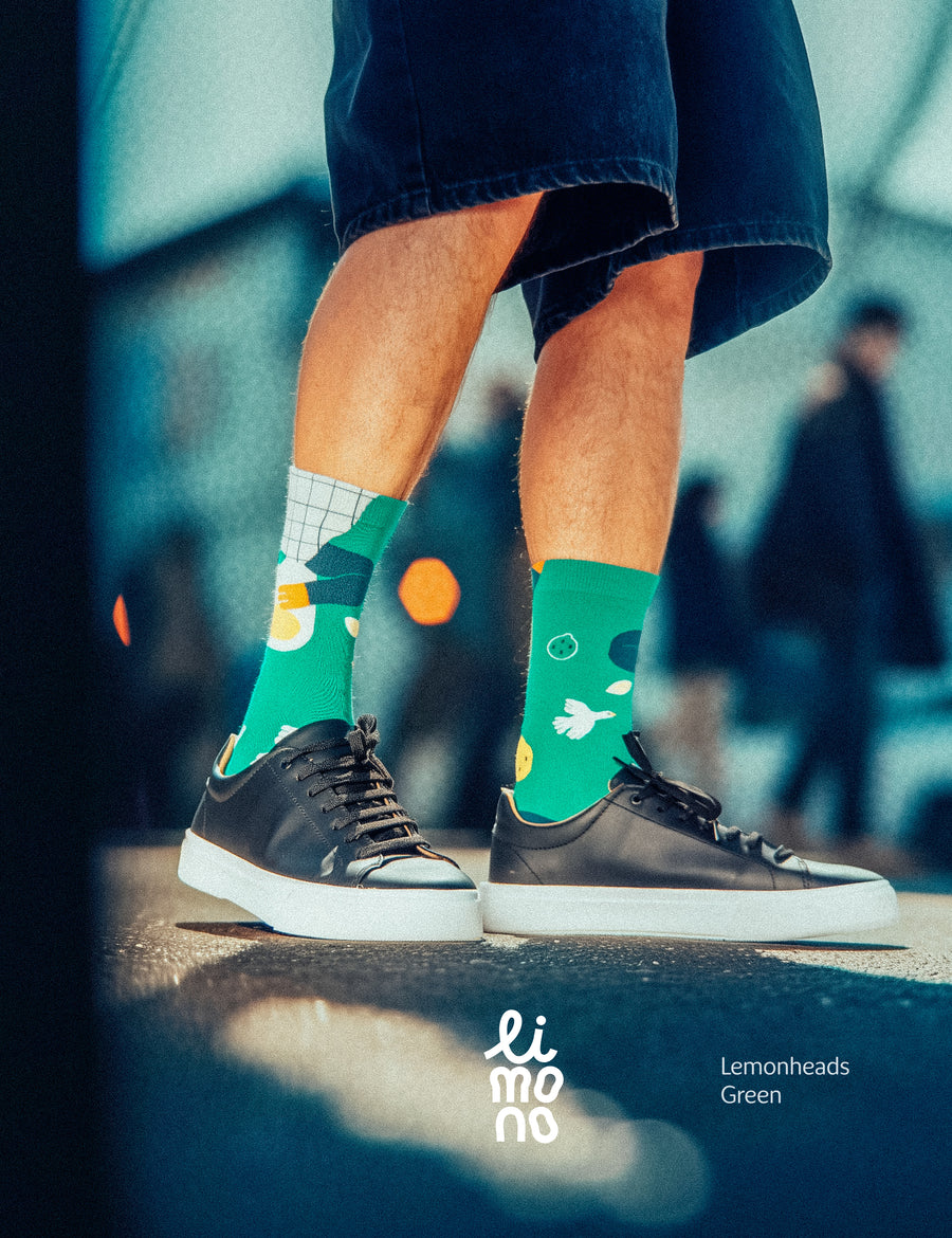 Cropped legs back view on white wearing Limono Lemonheads Green socks