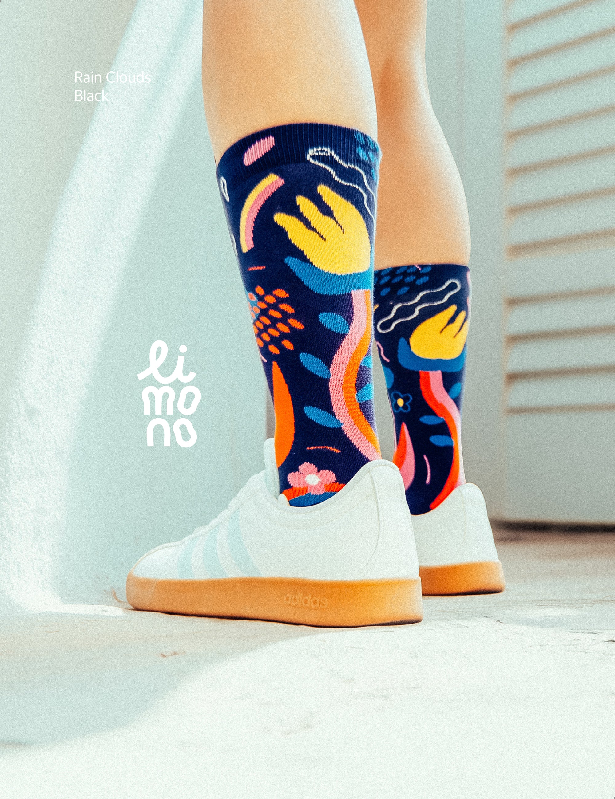 Limono Socks Rain Clouds collection. Illustrated socks on trend made in Portugal. Organic combed cotton. Colorful abstract-patterned socks worn with white sneakers on a light background