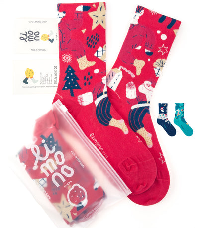 Limono Christmas Red socks flat lay with Santa, tree and snowflake motifs, brand label and plastic bag