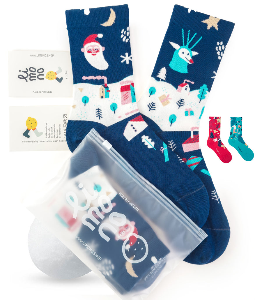Limono Christmas Navy socks flat lay with Santa, deer and house motifs, brand label and plastic bag