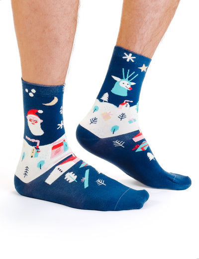 Limono Christmas Navy socks with Santa, deer and house motifs worn on legs
