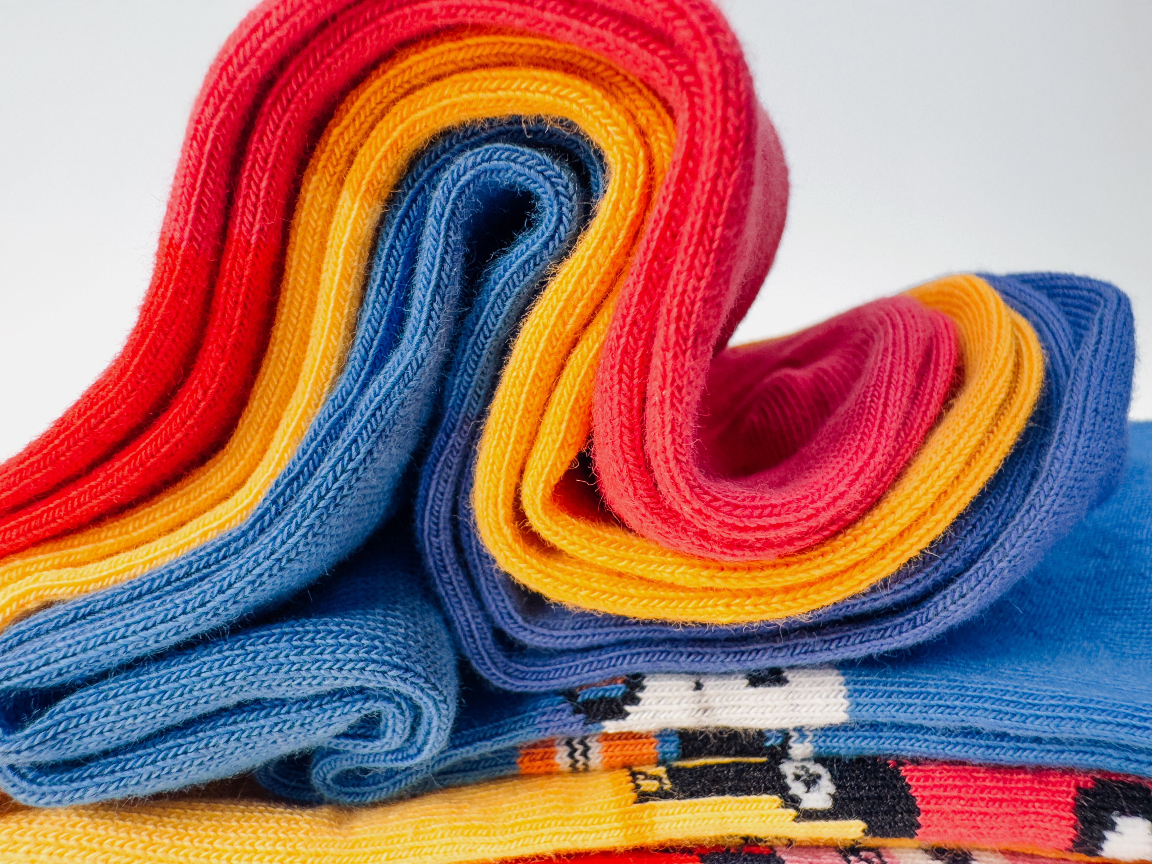 Limono Socks Robots Day collection. Illustrated socks on trend made in Portugal. Organic combed cotton. Stack of colorful folded Limono Robots Day socks on a white background