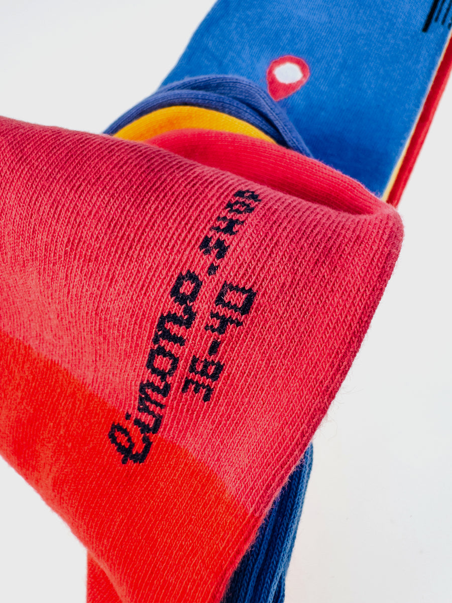 Stack of folded Limono Robots Day socks Blue, Yellow, Red with embroidered limono size text