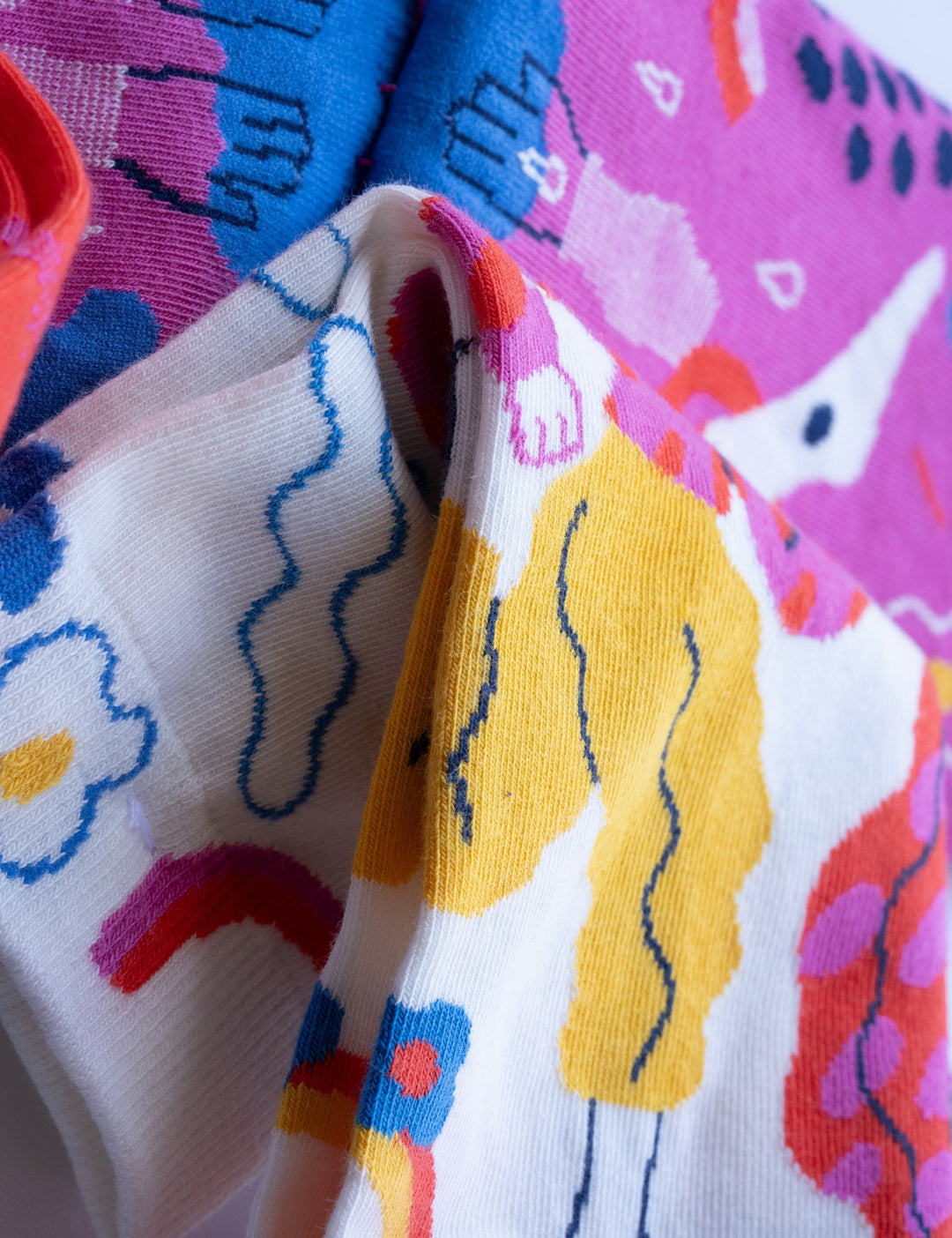 Limono Rain Clouds White socks jacquard knit macro, cloud-head character and rainbow on ivory cotton