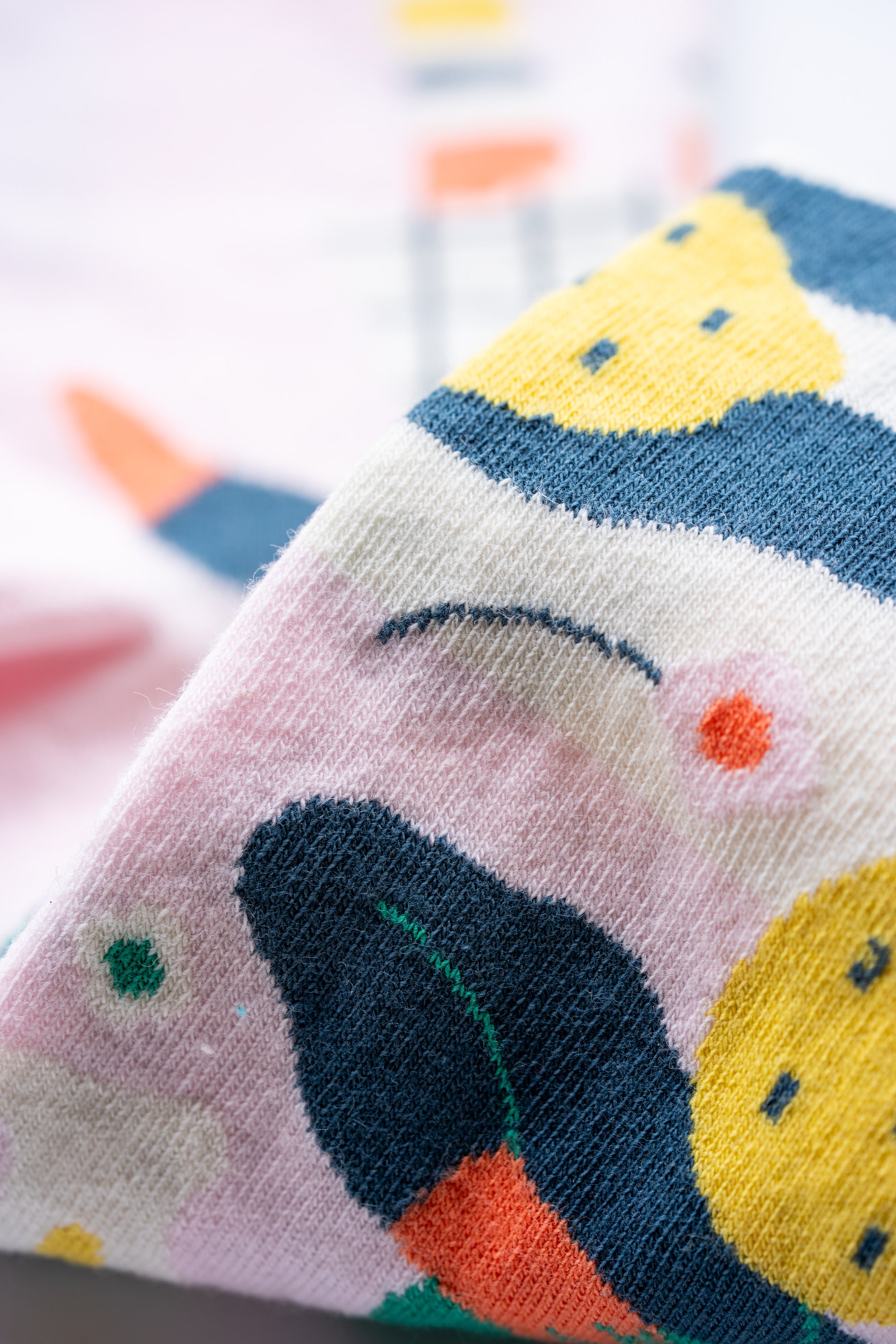 Limono Lemonheads Rose socks jacquard knit macro showing lemons and lemon-head character on pink cotton