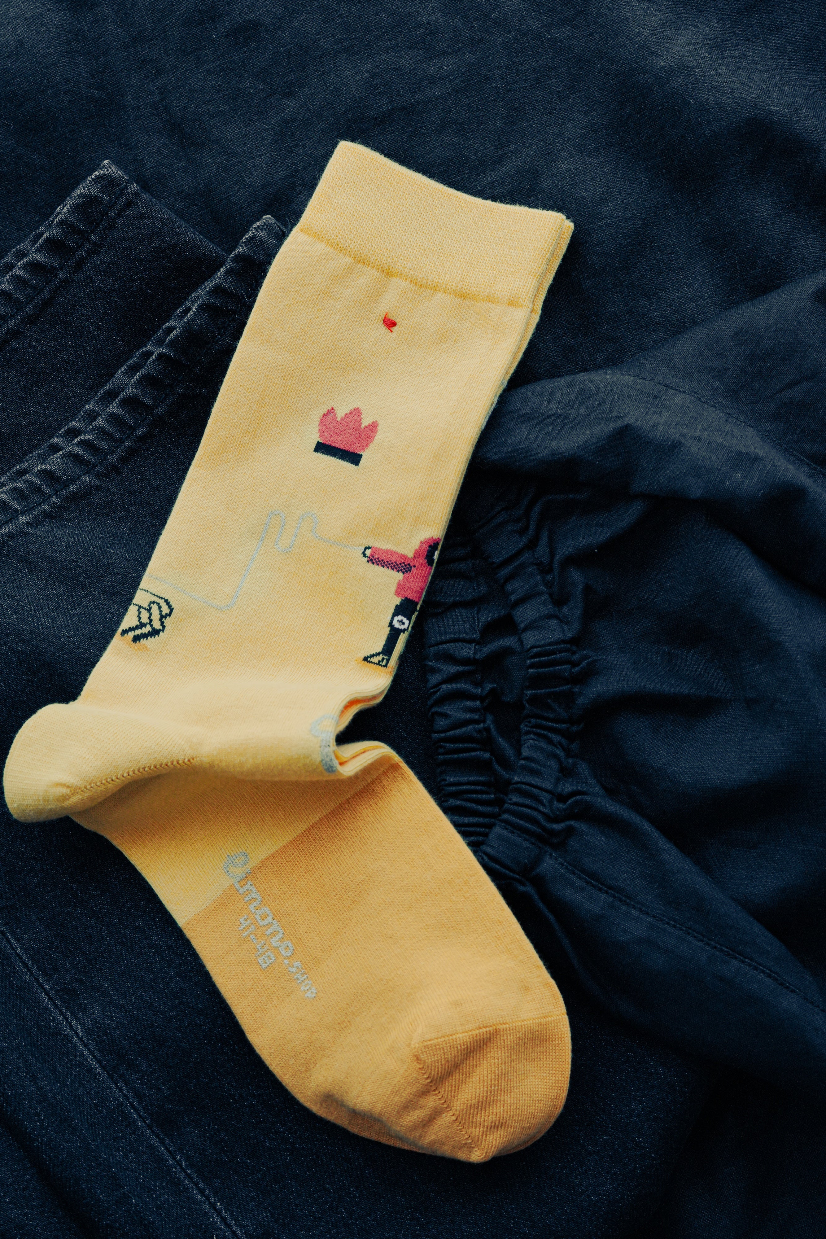 Limono Robots Day Yellow socks jacquard knit macro showing robotic dog and anthropomorphic robot motifs