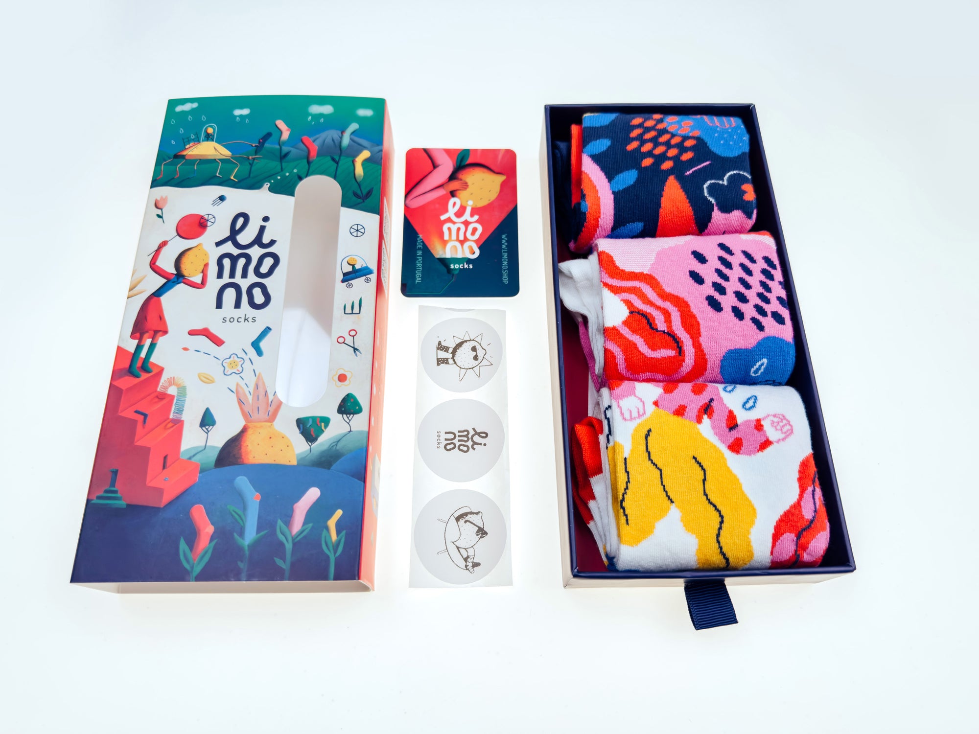 Limono Rain Clouds gift box flat lay with three socks, branded card and round stickers