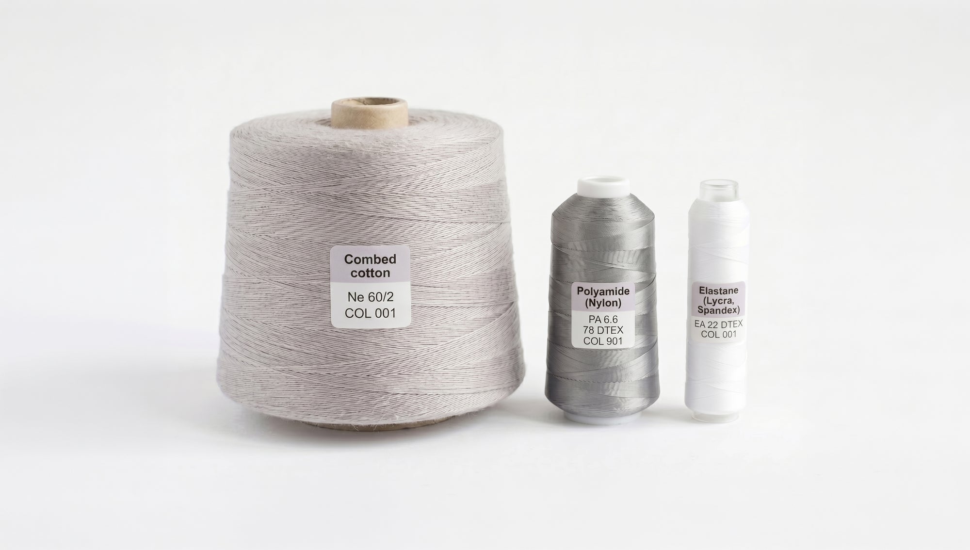 Three yarn cones used in Limono socks, combed cotton, polyamide and elastane